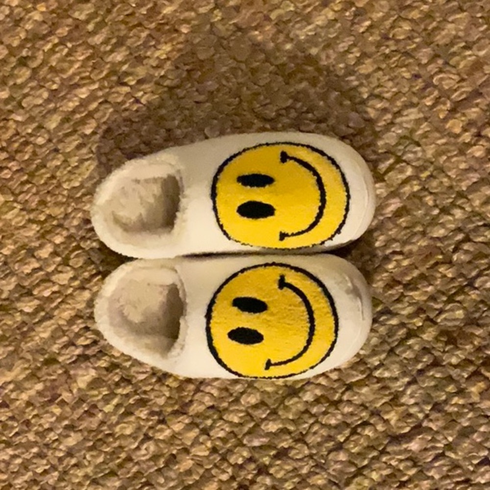 White fuzzy happy face slippers